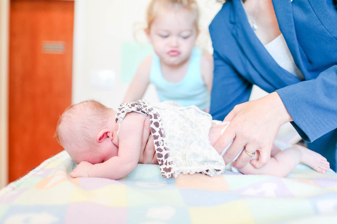 newborn receiving first chiropractic adjustment