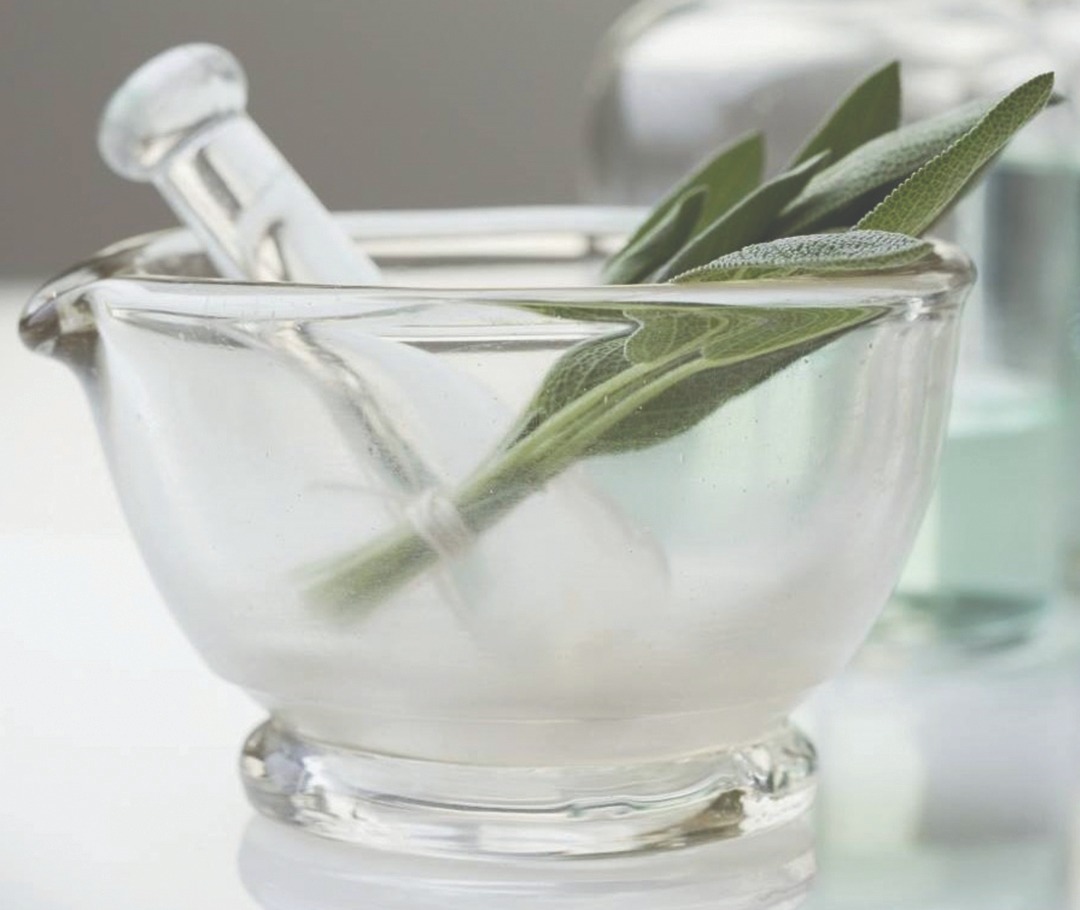 Image of mortar and pestle with herbs.